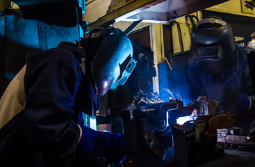 Industrial steel welder in factory
