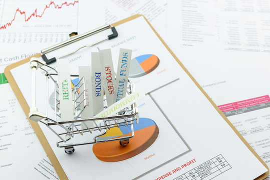 Various type of financial and investment products in a shopping cart i.e. REITs, ETFs, bonds, stocks. Sustainable portfolio management, long term wealth management with risk diversification concept.