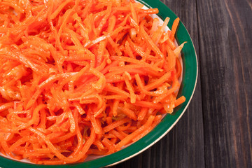 Hot carrot salad in  plate  on wooden background