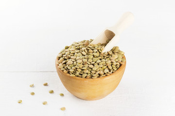 Green lentil on white wooden background