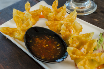 fried crab and cheese wanton with spicy sauce, selective focus.