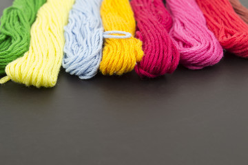 Threads for sewing on a black background

