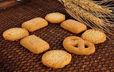 cookies and ear of barley on background
