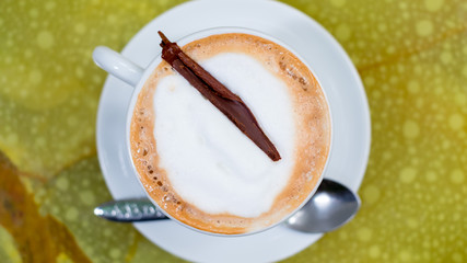 Hot chocolate in a white cup on rock table