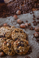 Roasted coffee beans, muesli with nuts on the wooden background