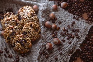 Roasted coffee beans, muesli with nuts on the wooden background