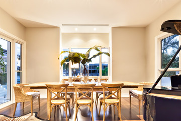 Dining table with piano and tiger printed floor matt in a luxury
