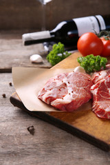 Marbled beef steak and spices on wooden background