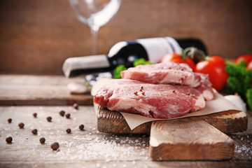 Marbled beef steak and spices on wooden background
