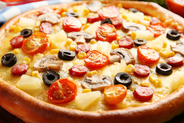 Delicious pizza with vegetables and meat, close-up