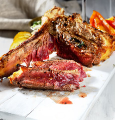 steak with grilled vegetables and sauce on a white background
