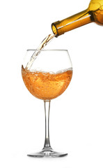 White wine pouring in glass, isolated on white