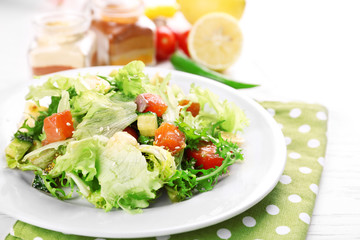 Tasty salmon salad on light wooden background