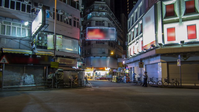 Neon lights on Tsim Sha Tsui street timelapse with traffic.
