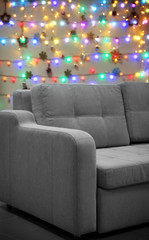 Grey couch on Christmas lights background