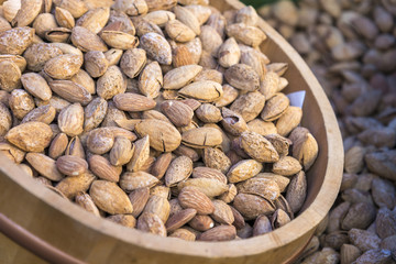 Almond nuts on wood tank in shop, background and texture