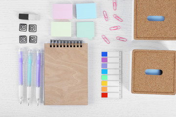 Notebook with stationery on a white table