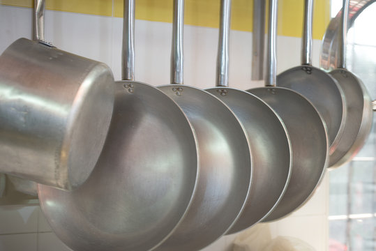 Pots And Pans Hanging In The Professional Kitchen