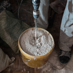 Stirring mortar using drills