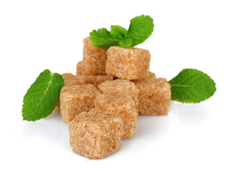 Pile of brown sugar cubes and stevia isolated on white background