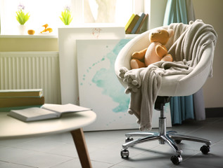 Modern living room interior in grey tones with teddy bear on the chair