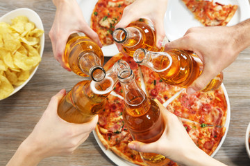 Friendly party with hot pizza and drinks, close up
