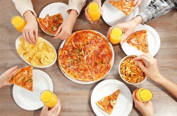 Friendly party with hot pizza and drinks, close up
