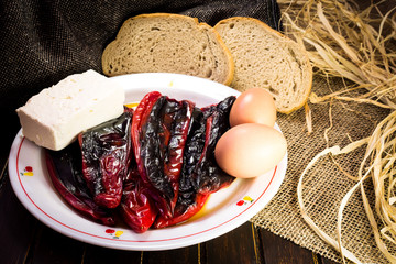 Eggs, cheese, red papers and slices of bred on fabric texture background 