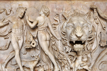 Bas-relief and sculpture of ancient Roman Gods and a lion head