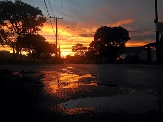Reflection in the water puddle at the sunset