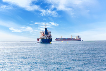 Rendezvous of two ships on the high seas. Commercial container ship on the high seas