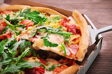 Sliced fresh pizza on wooden table closeup
