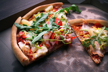 Sliced fresh pizza on cardboard background