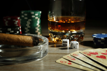 Set to playing poker with cards and chips on wooden table closeup