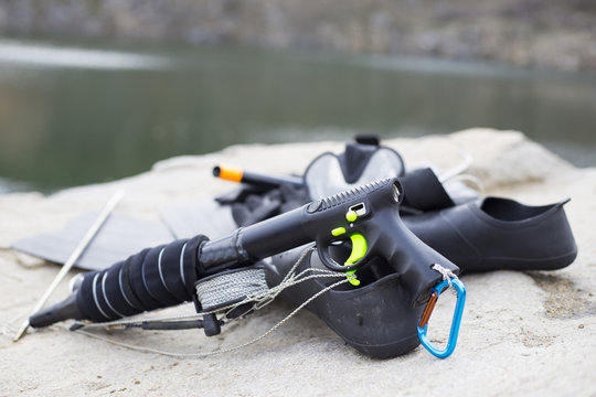 Equipment underwater hunter rests on a rock. © vetal1983