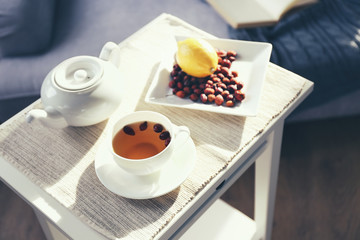 Rose hip and lemon tea on table in the room