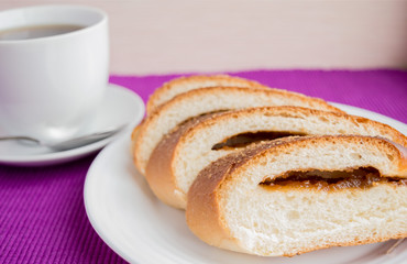 Sweet roll with apple stuffing and cup of tea