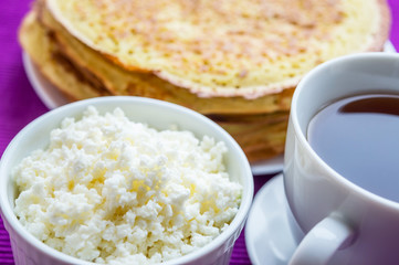Pancakes with cheese and a cup of tea