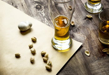 Beer and pistachios on a table. Glasses of beer
