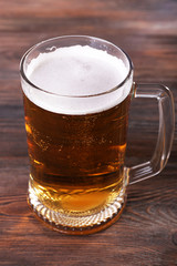Glass of beer on wooden background