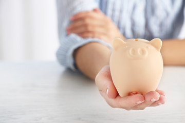 Woman holding piggy bank closeup