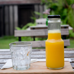 Juice bottle on wood background - Fresh orange juice on wooden