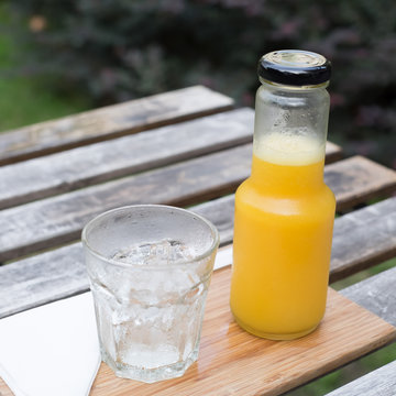 Juice bottle on wood background - Fresh orange juice on wooden