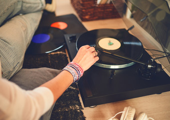 Woman listening vinyl at home