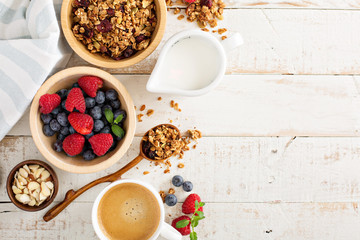 Breakfast table with granola and fresh berries