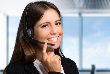 Female customer support operator with headset and smiling
