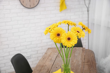 Beautiful bouquet of yellow gerbera flowers on wooden table