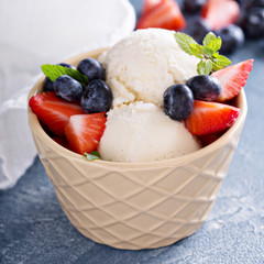Vanilla ice cream scoops with berries