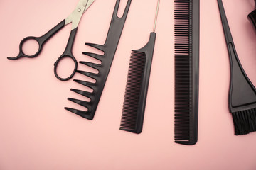 Hairdresser set with various accessories on pink background