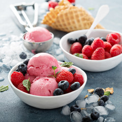 Raspberry ice cream in white bowl
